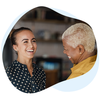 Two women smiling and talking