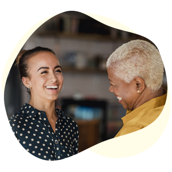 Two women smiling and talking